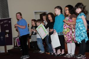 Children with Birthday cards in church.